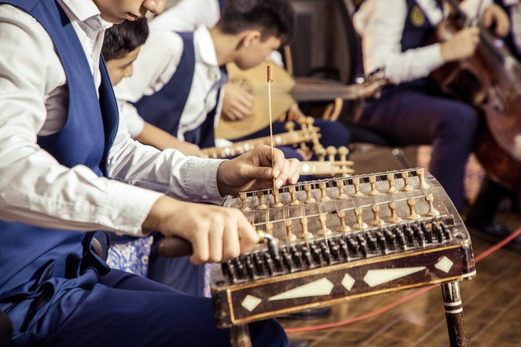 Crop musician tuning classical santoor instrument